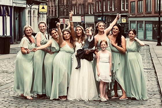 Bridal party pose on street